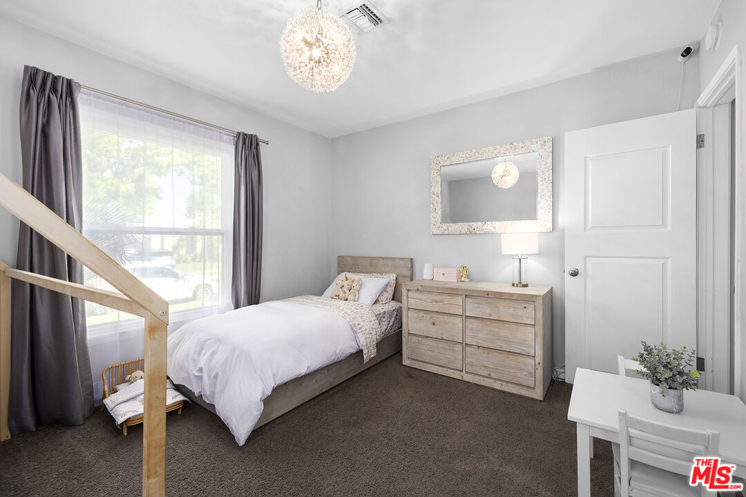 6521 Balcom Avenue Reseda, CA 91335 - Photo 19 of 35 a bedroom with a bed and a window