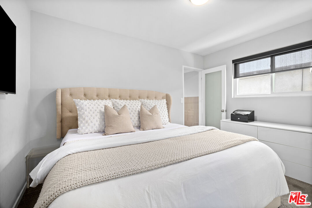 6521 Balcom Avenue Reseda, CA 91335 - Photo 23 of 35 a bedroom with a bed and a large window