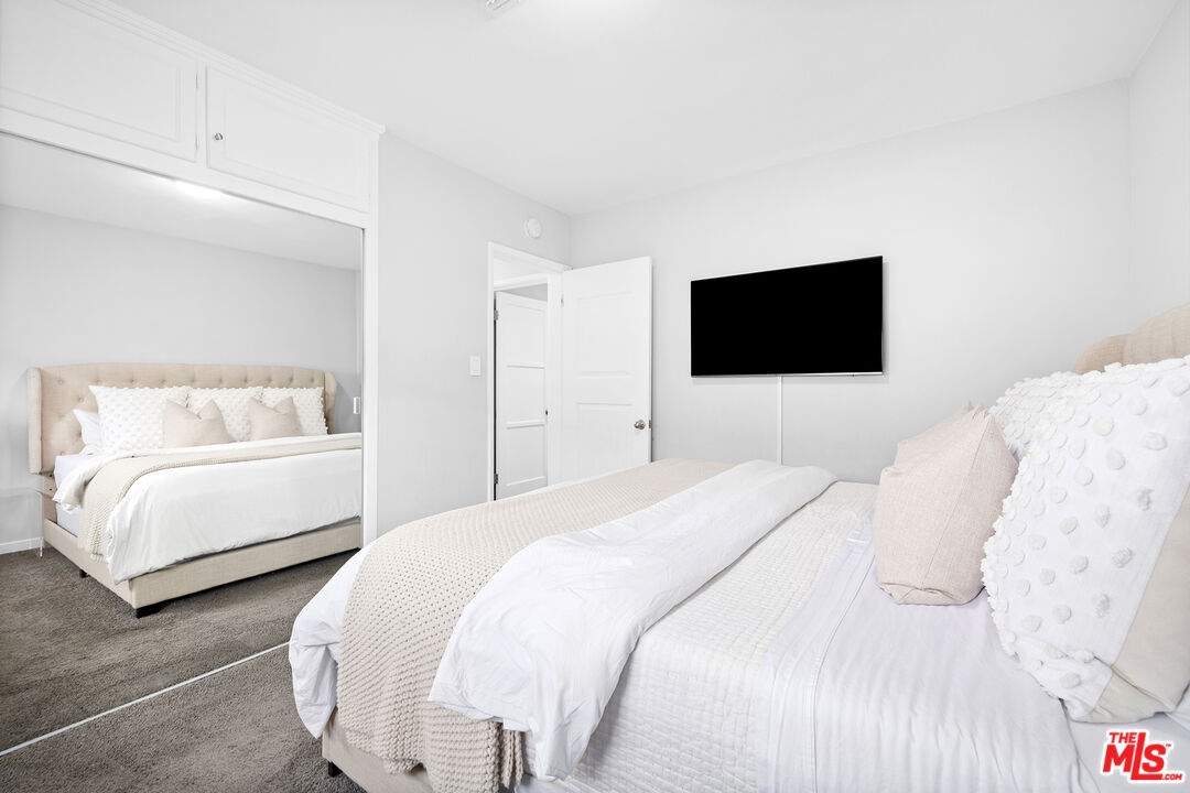 6521 Balcom Avenue Reseda, CA 91335 - Photo 25 of 35 a bedroom with a bed and a flat screen tv