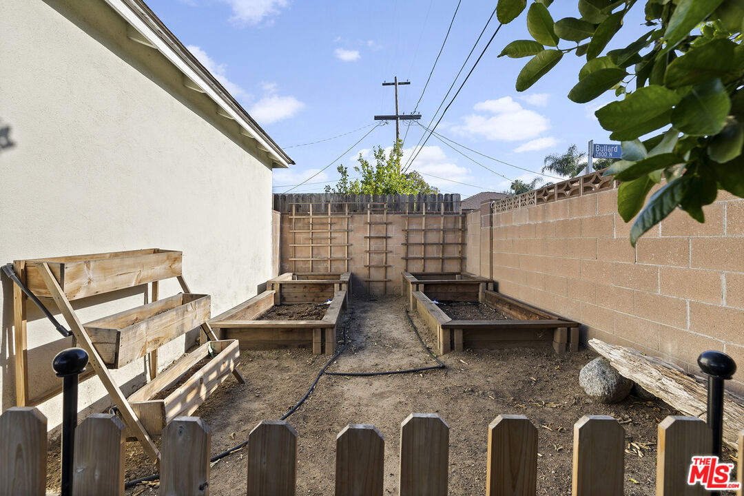 6521 Balcom Avenue Reseda, CA 91335 - Photo 32 of 35 a view of a backyard with chairs and potted plants