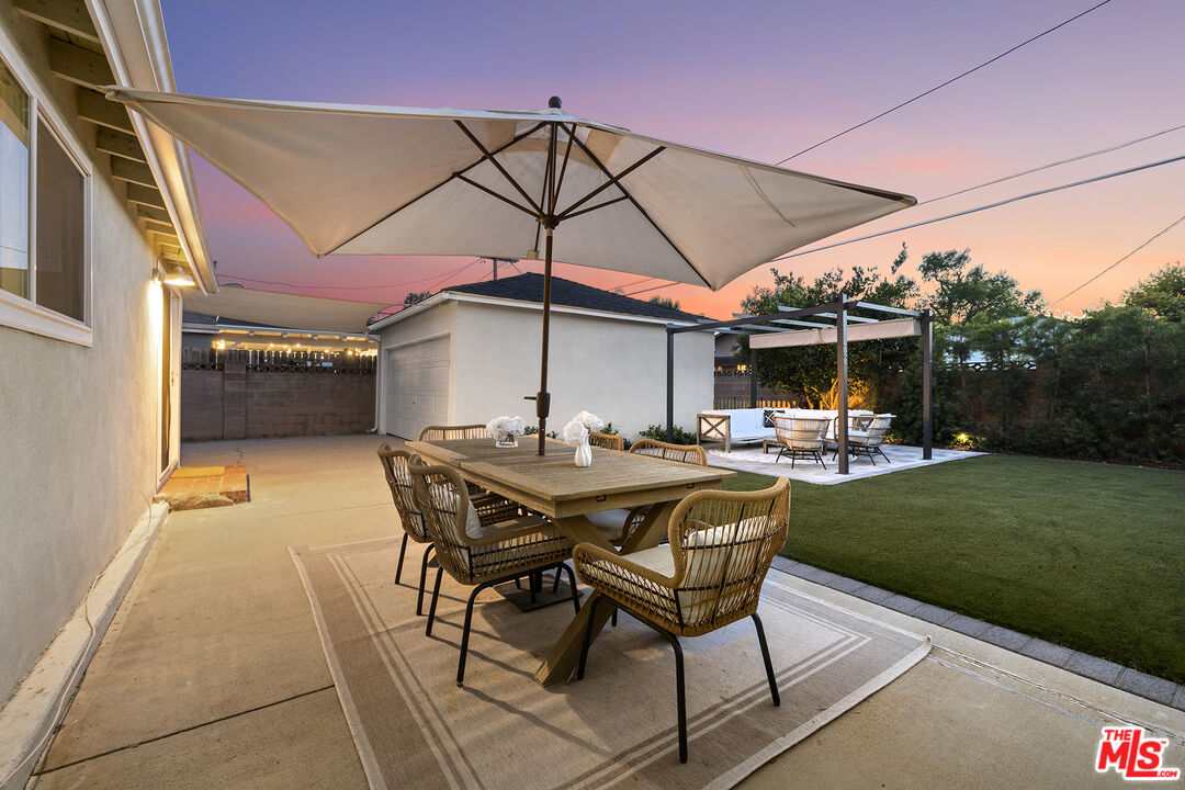 6521 Balcom Avenue Reseda, CA 91335 - Photo 34 of 35 a patio with a table and chairs under an umbrella