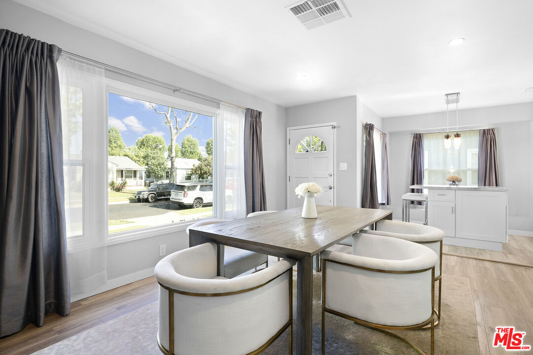 6521 Balcom Avenue Reseda, CA 91335 - Photo 5 of 35 a dining room with furniture and a potted plant