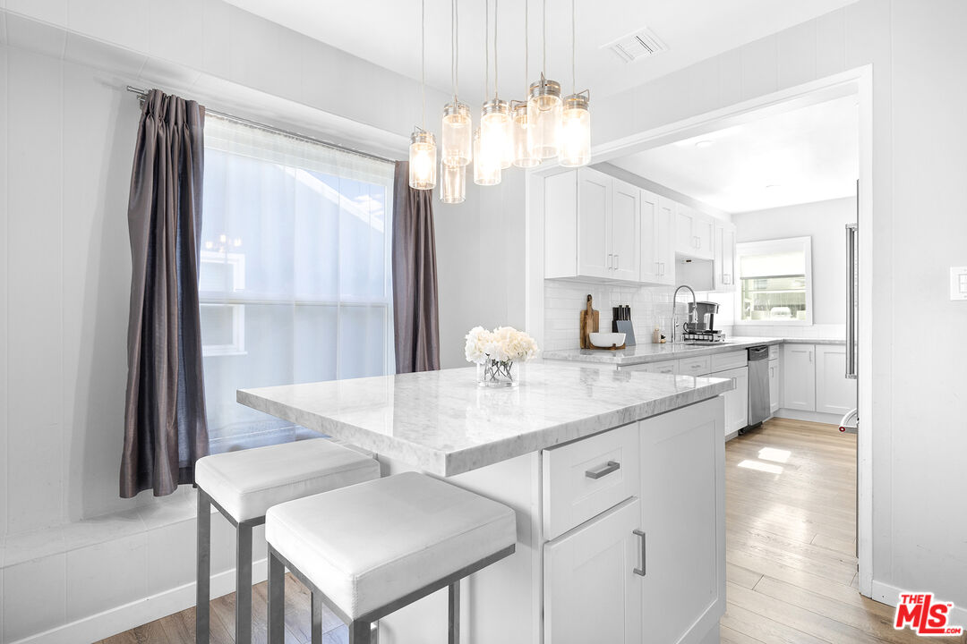 6521 Balcom Avenue Reseda, CA 91335 - Photo 8 of 35 a kitchen with a table and chairs
