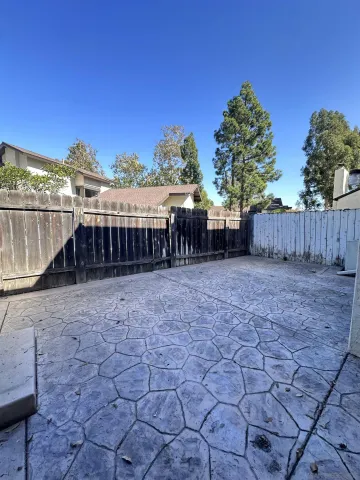a view of a house with a yard and furniture