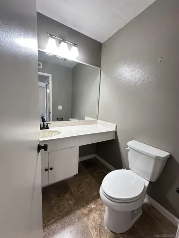 a bathroom with a sink toilet and mirror