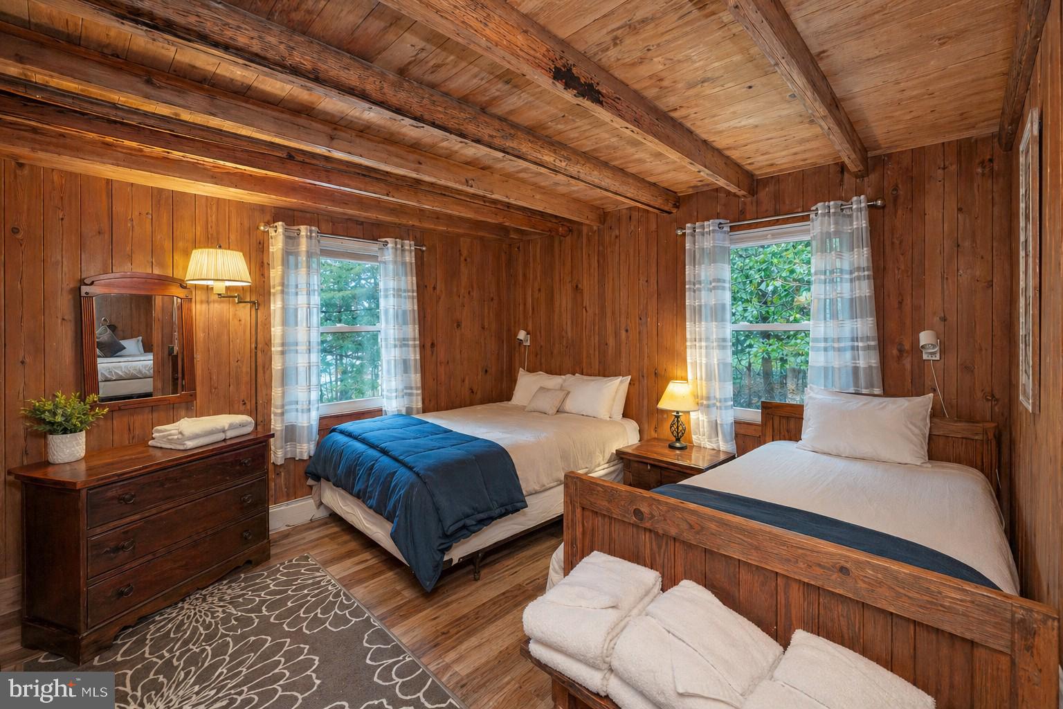 2187 State Park Road Swanton, MD 21561 - Photo 18 of 29 a bedroom with a bed and wooden floor