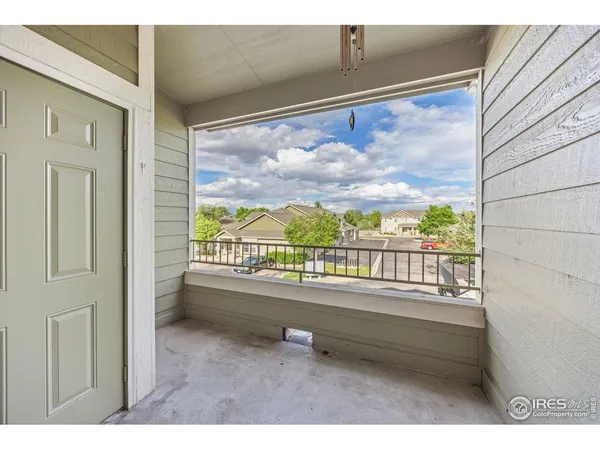 a balcony with furniture and a view of city
