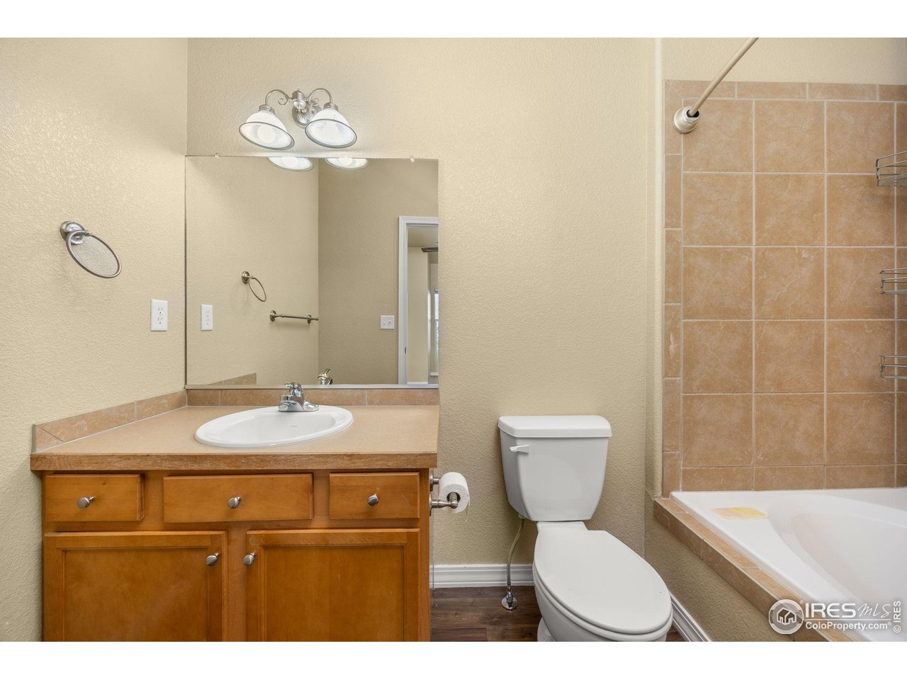 1900 68th Avenue, Unit 810 Greeley, CO 80634 - Photo 16 of 24 a bathroom with a sink a toilet and mirror