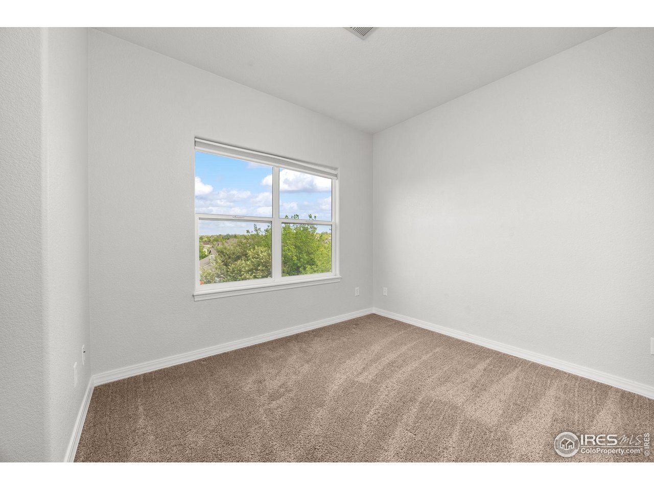 1900 68th Avenue, Unit 810 Greeley, CO 80634 - Photo 18 of 24 a view of an empty room with a window