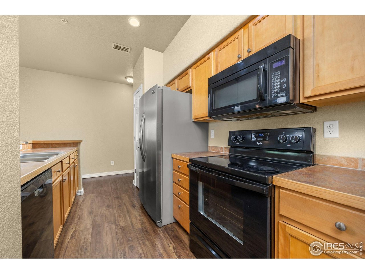 1900 68th Avenue, Unit 810 Greeley, CO 80634 - Photo 2 of 24 a kitchen with stainless steel appliances a stove microwave and refrigerator