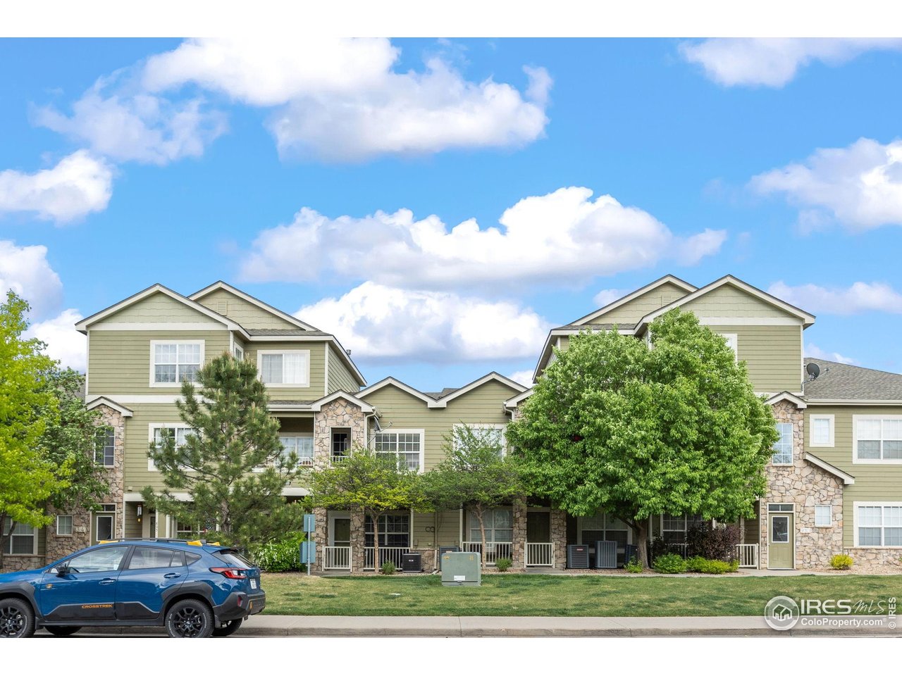 1900 68th Avenue, Unit 810 Greeley, CO 80634 - Photo 3 of 24 a front view of a house with a yard