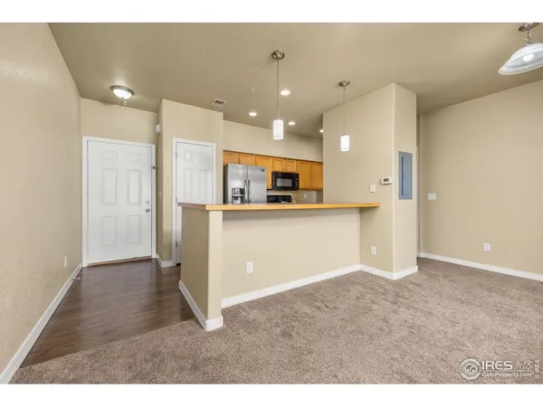 a view of kitchen with stainless steel appliances granite countertop a refrigerator a sink and a stove