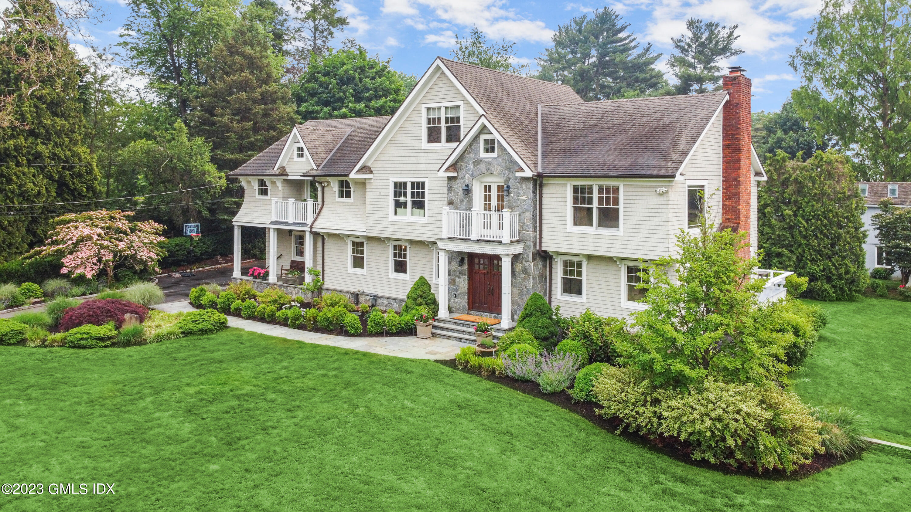 26 Twin Lakes Lane Riverside, CT 06878 - Photo 2 of 38 a aerial view of a house with a yard table and chairs