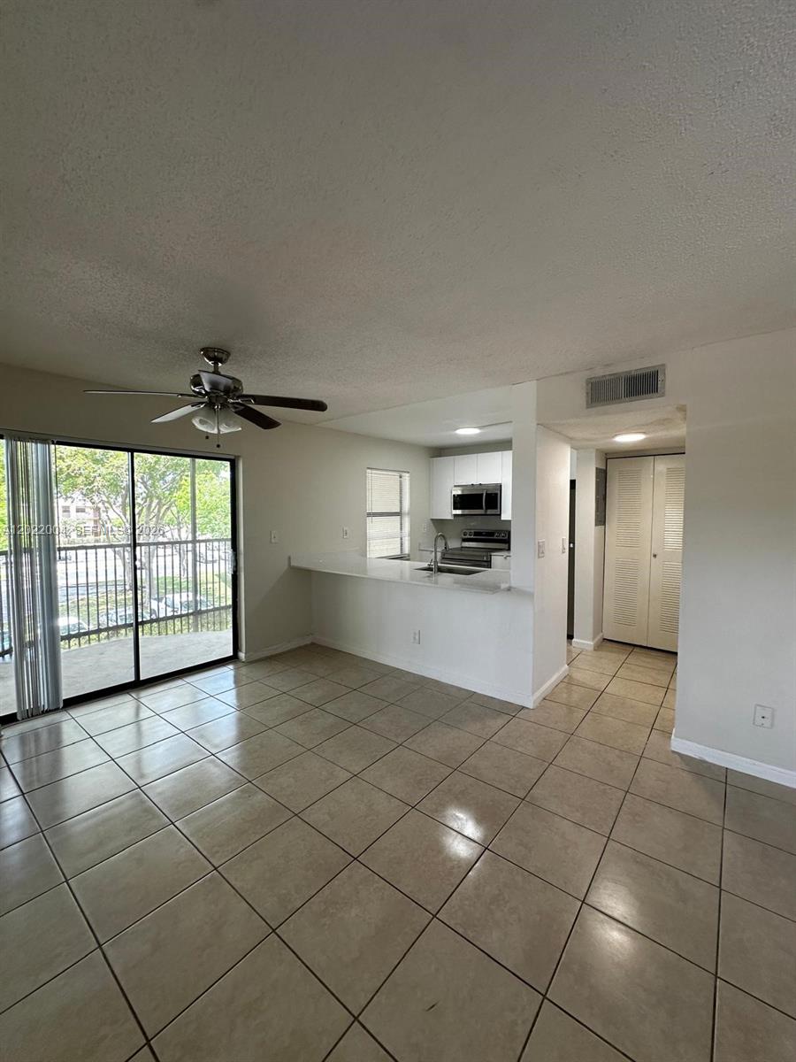 3400 Foxcroft Road, Unit 301 Miramar, FL 33025 - Photo 9 of 72 a view of a kitchen with furniture and an empty room