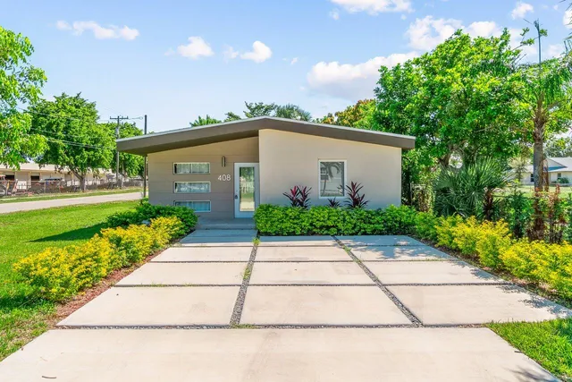a front view of a house with a yard and a garage