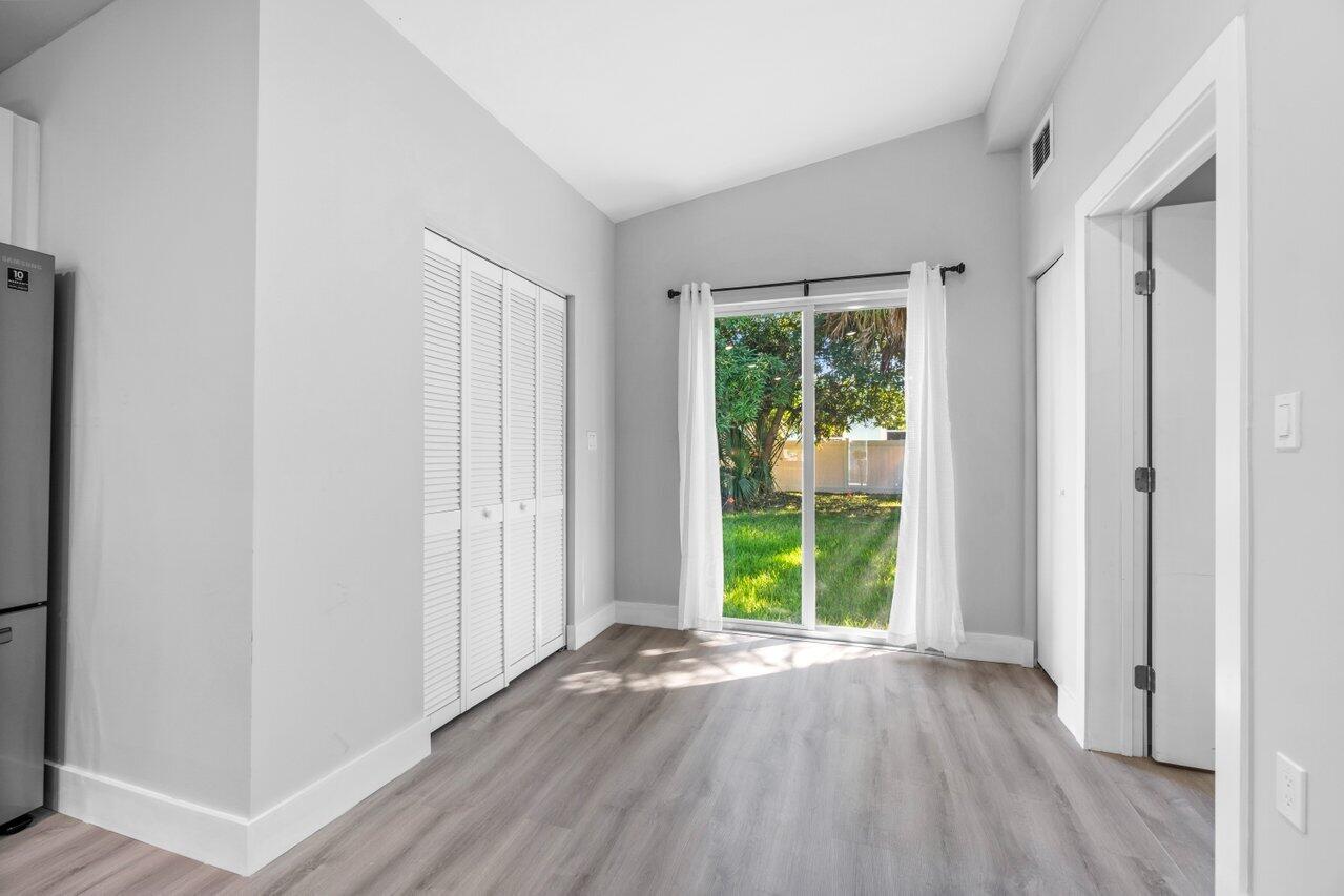 408 Southwest 4th Street Delray Beach, FL 33444 - Photo 14 of 31 an empty room with wooden floor and windows
