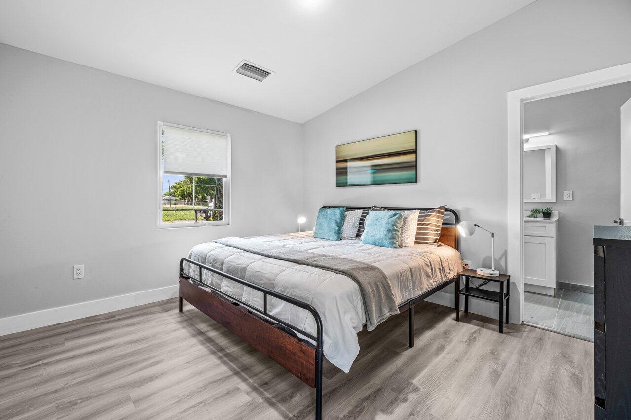 408 Southwest 4th Street Delray Beach, FL 33444 - Photo 16 of 31 a spacious bedroom with a bed and a window
