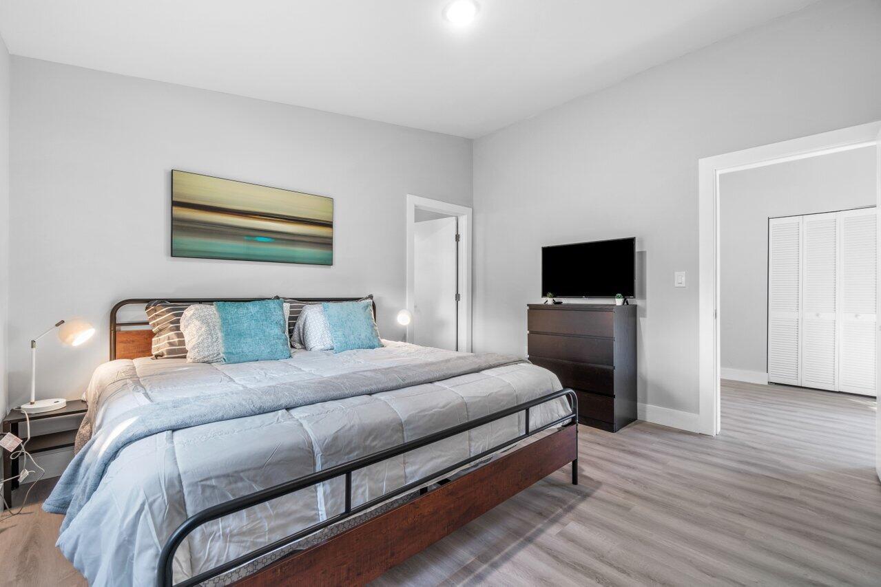 408 Southwest 4th Street Delray Beach, FL 33444 - Photo 17 of 31 a bedroom with a bed and a flat screen tv