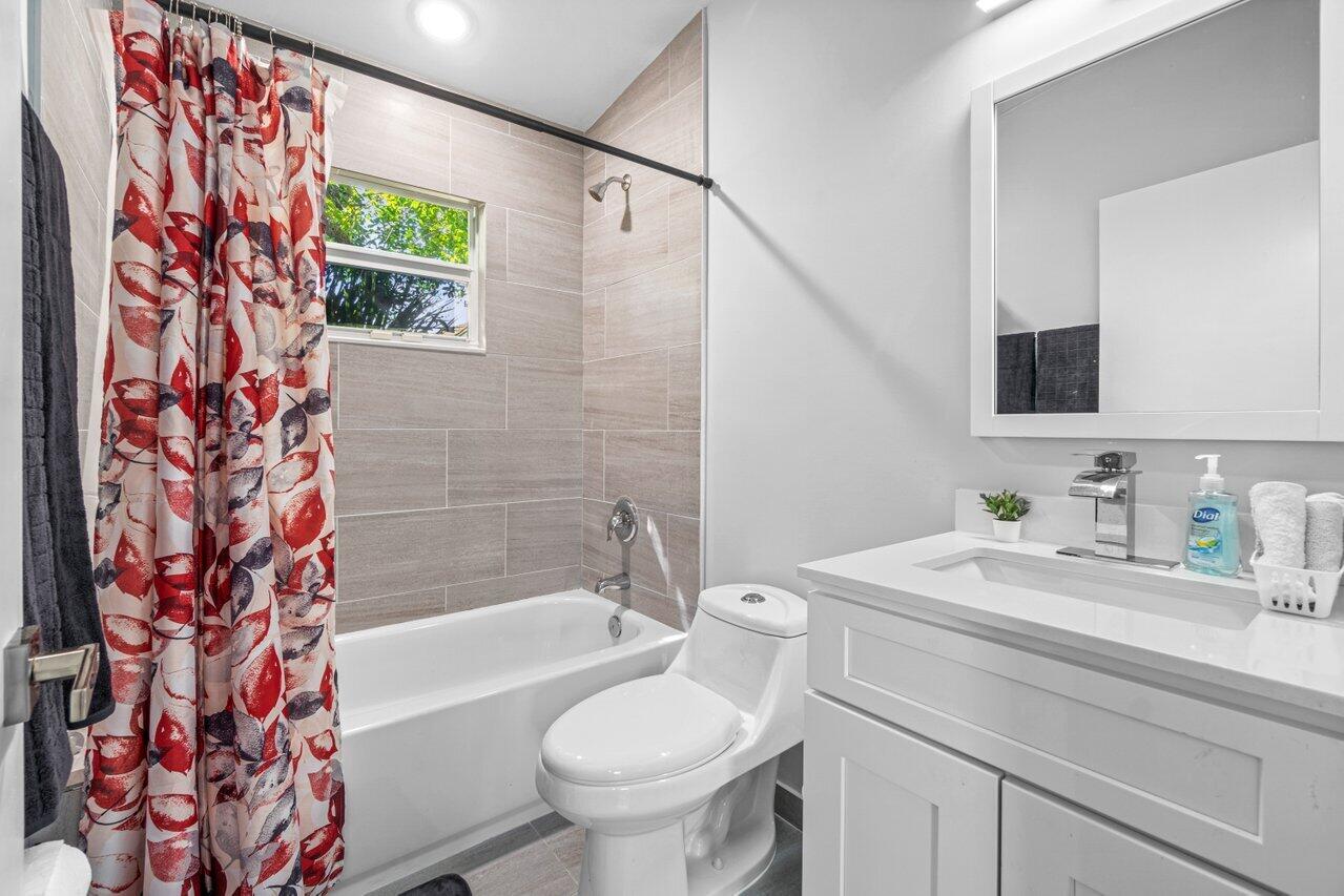 408 Southwest 4th Street Delray Beach, FL 33444 - Photo 22 of 31 a bathroom with a sink toilet and shower