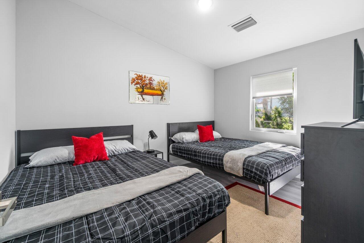 408 Southwest 4th Street Delray Beach, FL 33444 - Photo 23 of 31 a bedroom with two beds and a couch