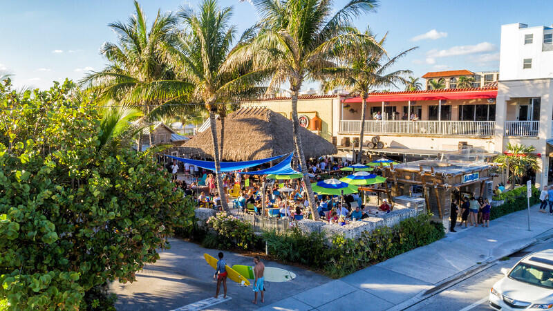 408 Southwest 4th Street Delray Beach, FL 33444 - Photo 31 of 31 a group of people sitting in front of a store