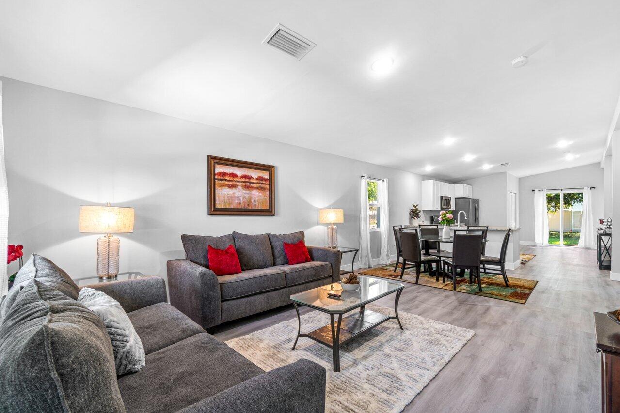 408 Southwest 4th Street Delray Beach, FL 33444 - Photo 6 of 31 a living room with furniture kitchen view and a wooden floor