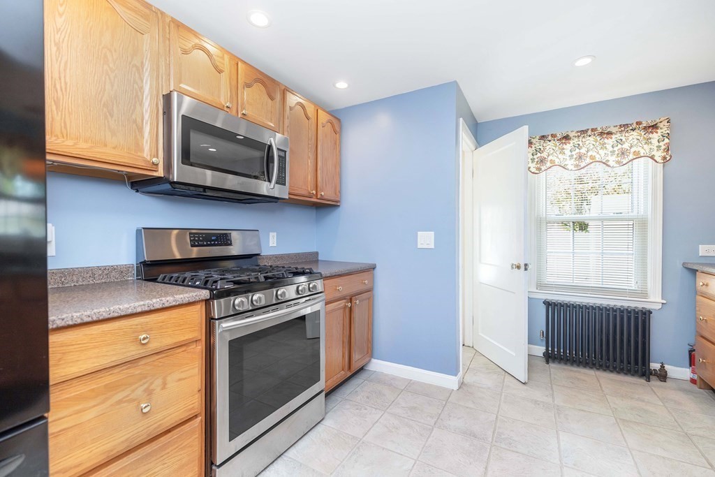 18 Redstone Drive Springfield, MA 01118 - Photo 14 of 31 a kitchen with stainless steel appliances granite countertop a stove and a microwave