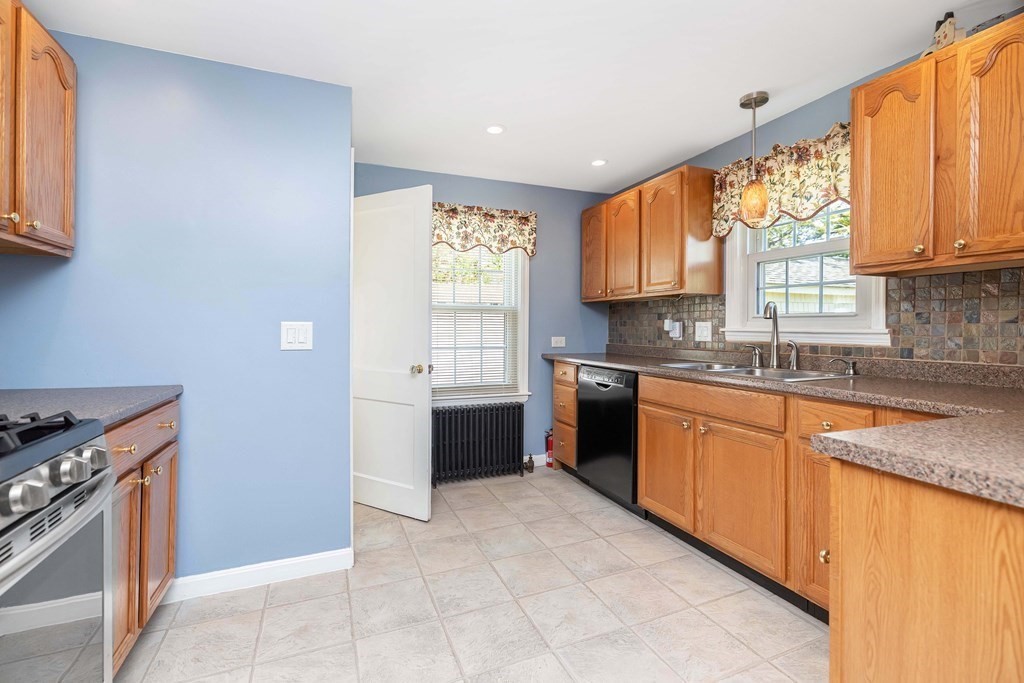 18 Redstone Drive Springfield, MA 01118 - Photo 15 of 31 a kitchen with stainless steel appliances granite countertop a stove a sink and a microwave
