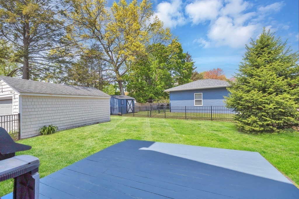 18 Redstone Drive Springfield, MA 01118 - Photo 26 of 31 a view of a backyard with potted plants and large tree