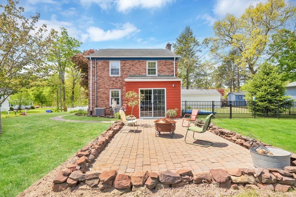18 Redstone Drive Springfield, MA 01118 - Photo 28 of 31 a backyard of a house with garden and barbeque oven