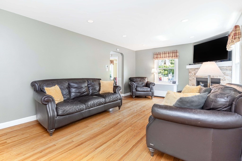 18 Redstone Drive Springfield, MA 01118 - Photo 3 of 31 a living room with furniture a flat screen tv and a window