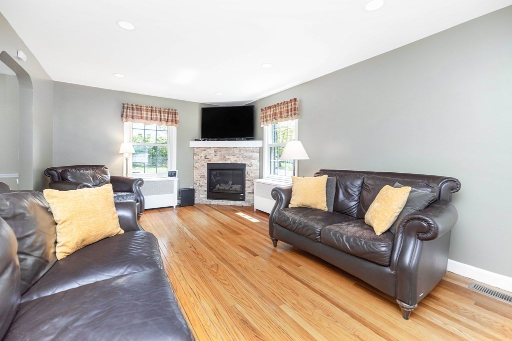 18 Redstone Drive Springfield, MA 01118 - Photo 4 of 31 a living room with furniture flat screen tv and a fireplace