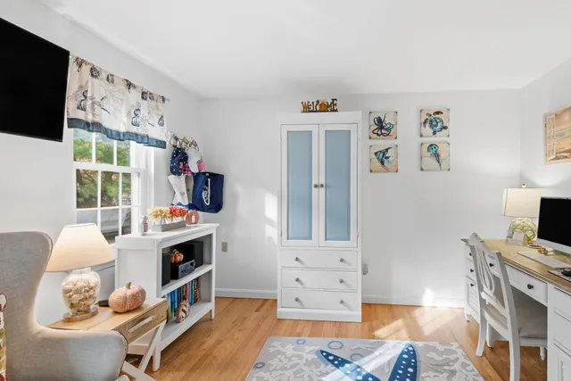 a bedroom with furniture and a flat screen tv