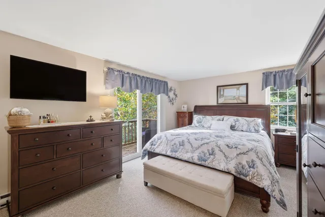a bedroom with a large bed and a flat screen tv