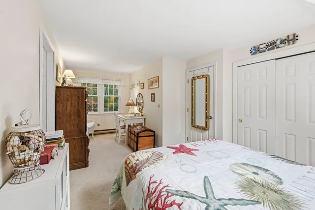 a bedroom with a bed dresser and a large mirror