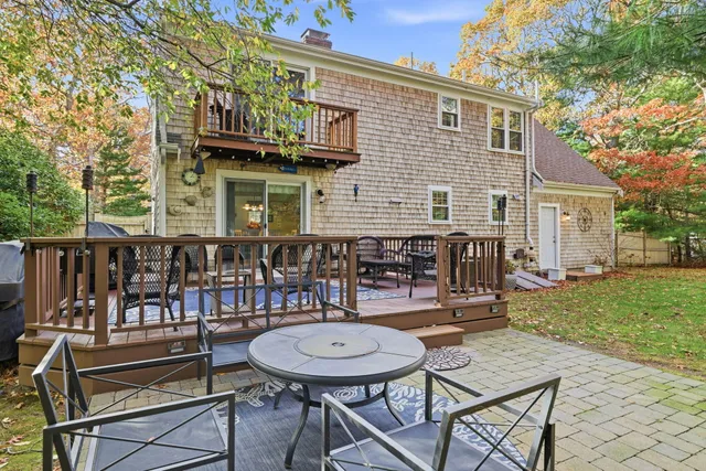 a view of a house with a chairs and table in a patio