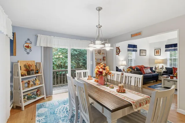 a living room with furniture a bookshelf and a window