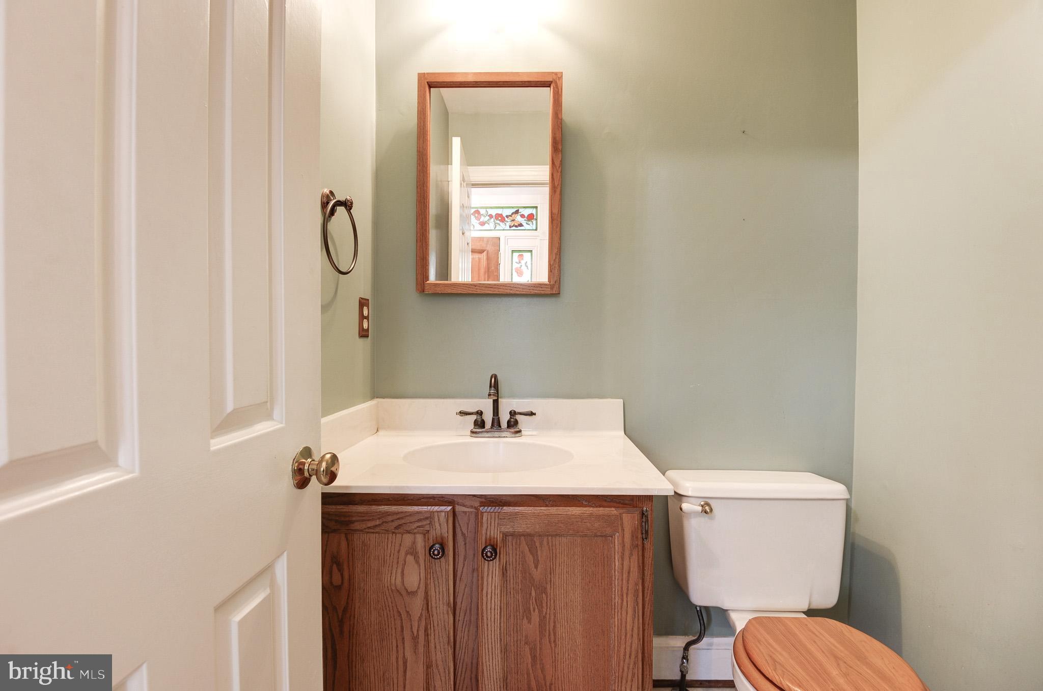 6814 Braddock Road Annandale, VA 22003 - Photo 11 of 68 a bathroom with a sink vanity mirror and toilet