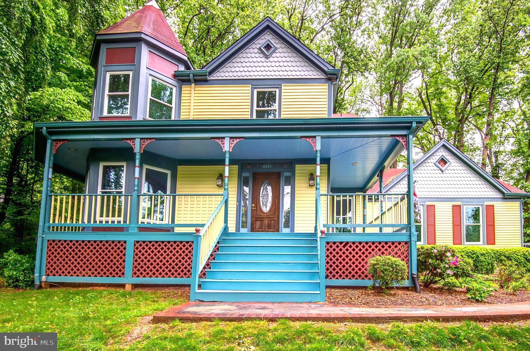 6814 Braddock Road Annandale, VA 22003 - Photo 2 of 68 a front view of a house with a yard and garage