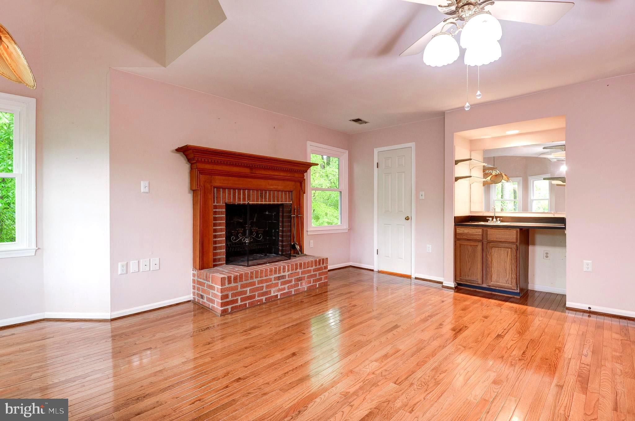 6814 Braddock Road Annandale, VA 22003 - Photo 22 of 68 a view of an empty room with a fireplace and a window
