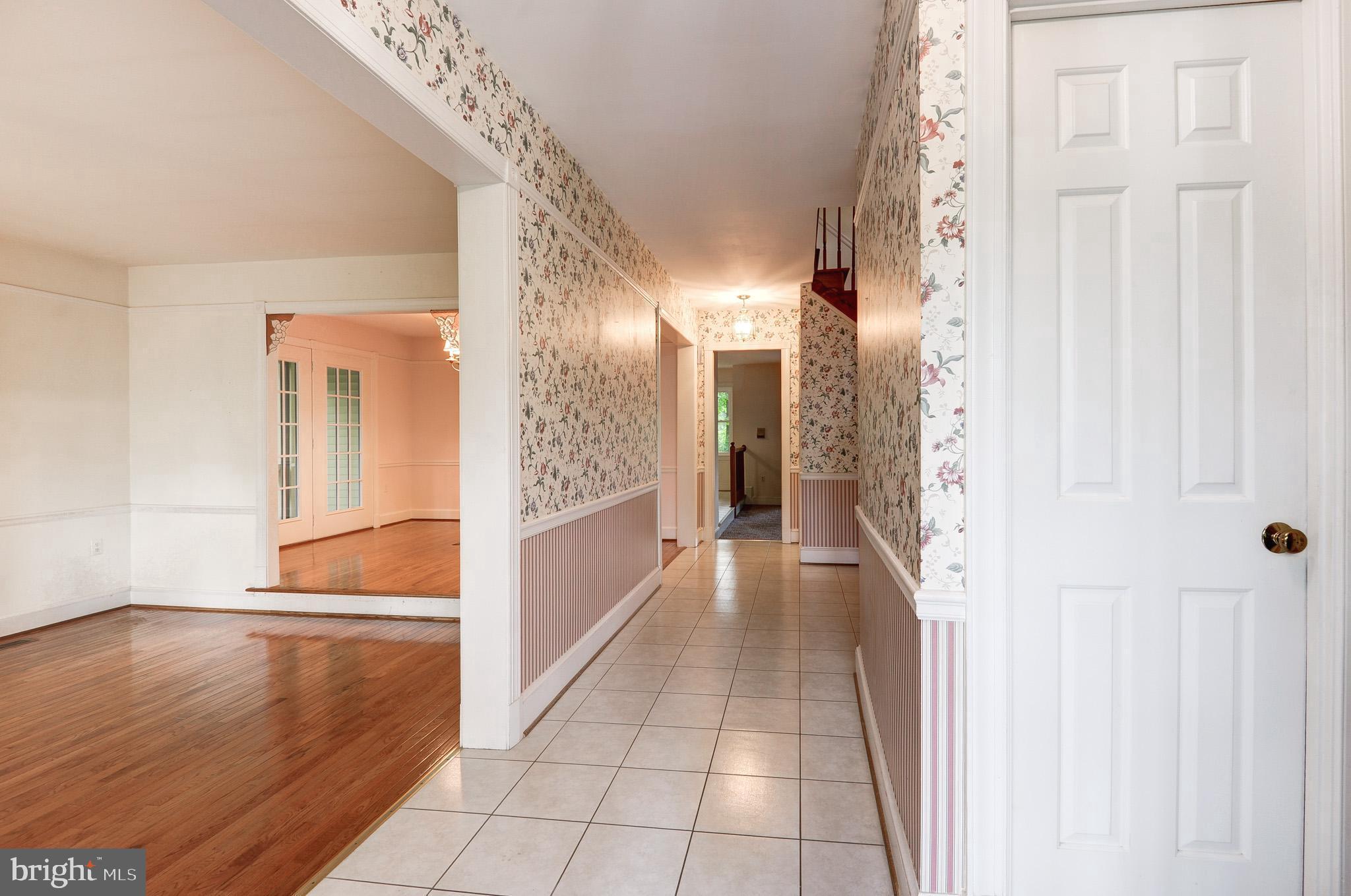 6814 Braddock Road Annandale, VA 22003 - Photo 3 of 68 a view of a hallway with wooden floor and staircase