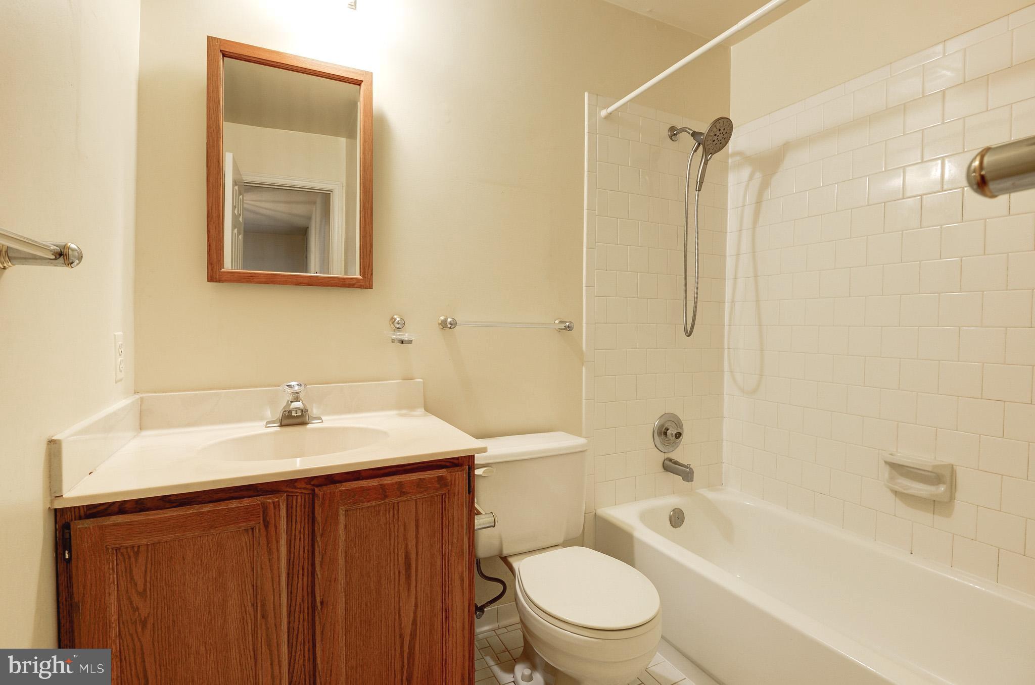 6814 Braddock Road Annandale, VA 22003 - Photo 34 of 68 a bathroom with a sink toilet vanity and shower
