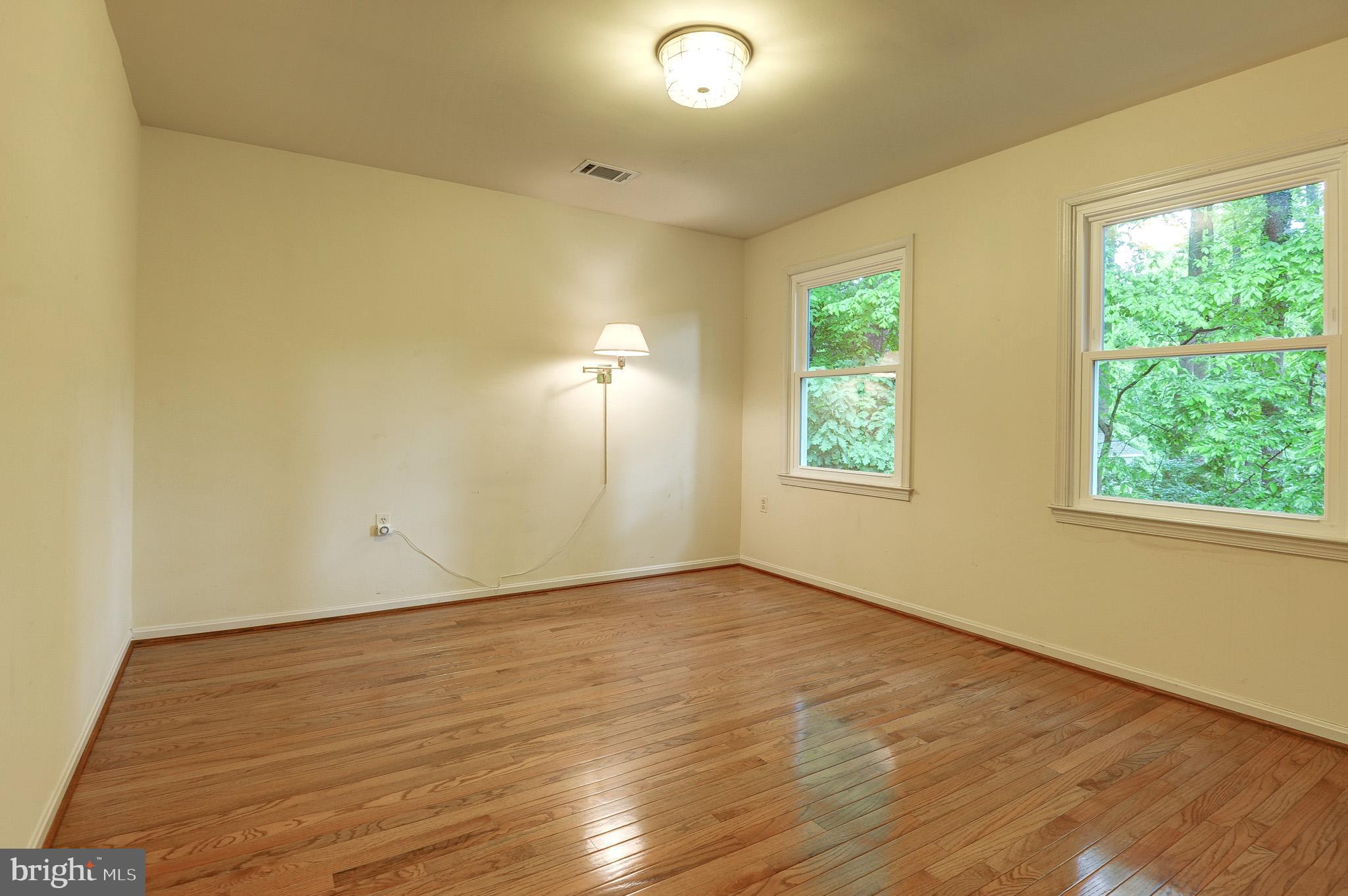 6814 Braddock Road Annandale, VA 22003 - Photo 35 of 68 an empty room with wooden floor and windows
