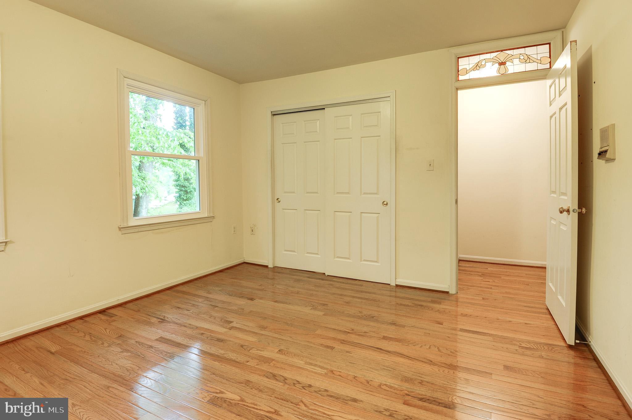 6814 Braddock Road Annandale, VA 22003 - Photo 36 of 68 a view of an empty room with wooden floor and a window