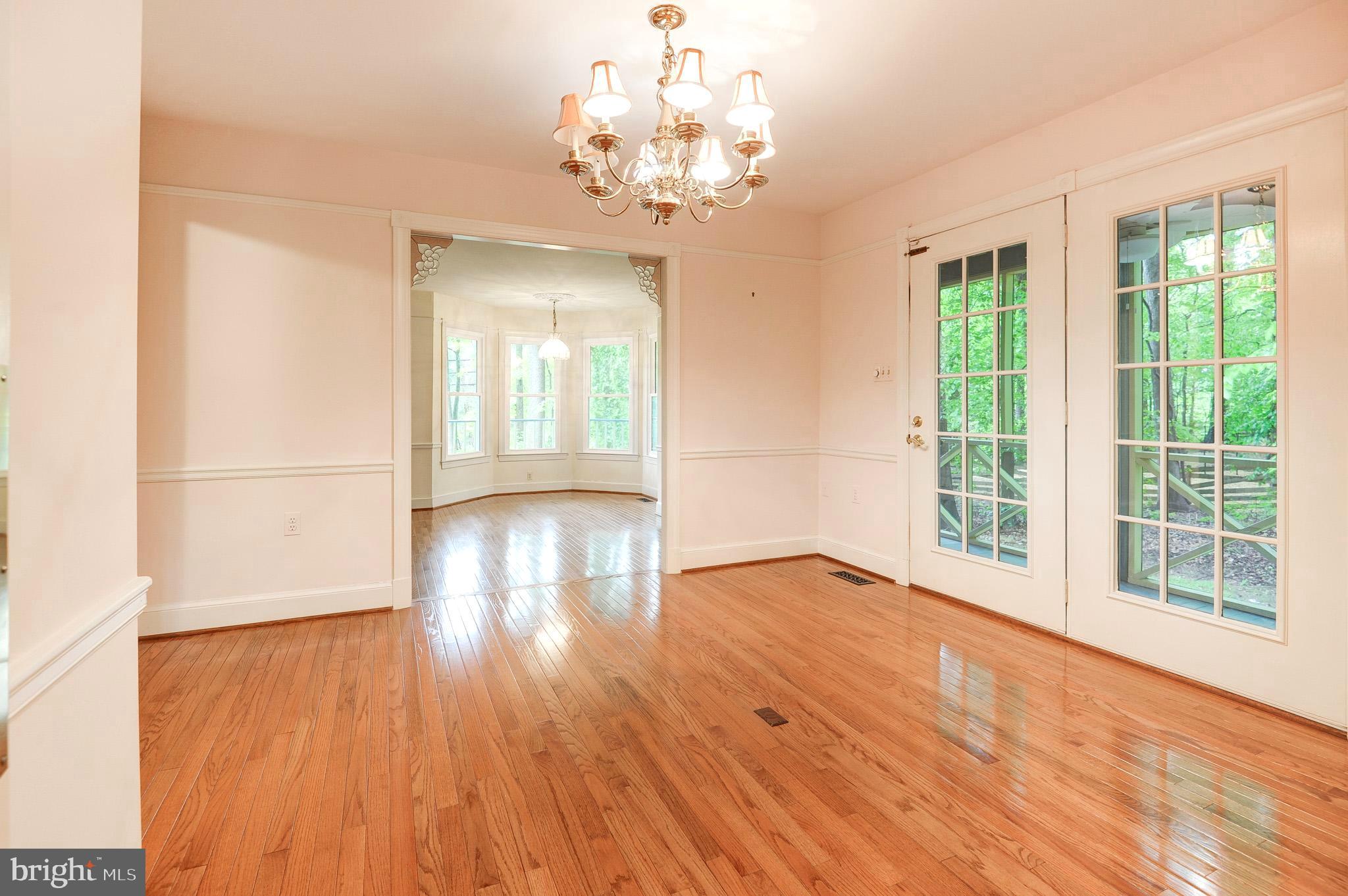 6814 Braddock Road Annandale, VA 22003 - Photo 10 of 68 a view of an empty room with wooden floor and a window