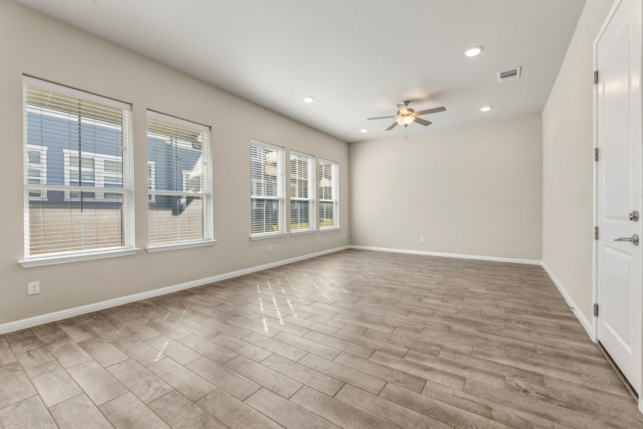 1015 Vista View Drive, Unit 2102 Georgetown, TX 78626 - Photo 11 of 40 a view of an empty room with a window and wooden floor
