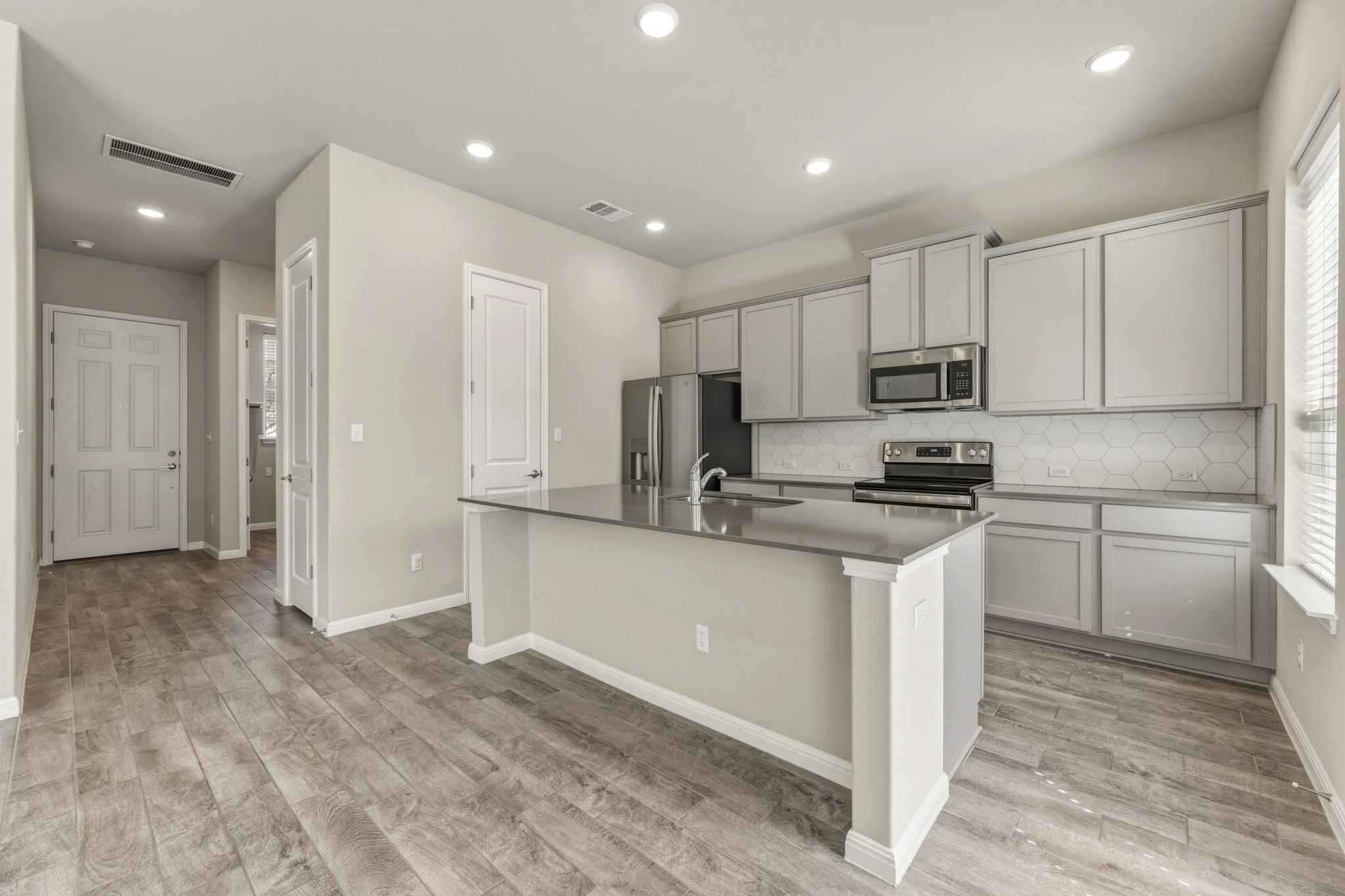 1015 Vista View Drive, Unit 2102 Georgetown, TX 78626 - Photo 13 of 40 a kitchen with white cabinets and stainless steel appliances