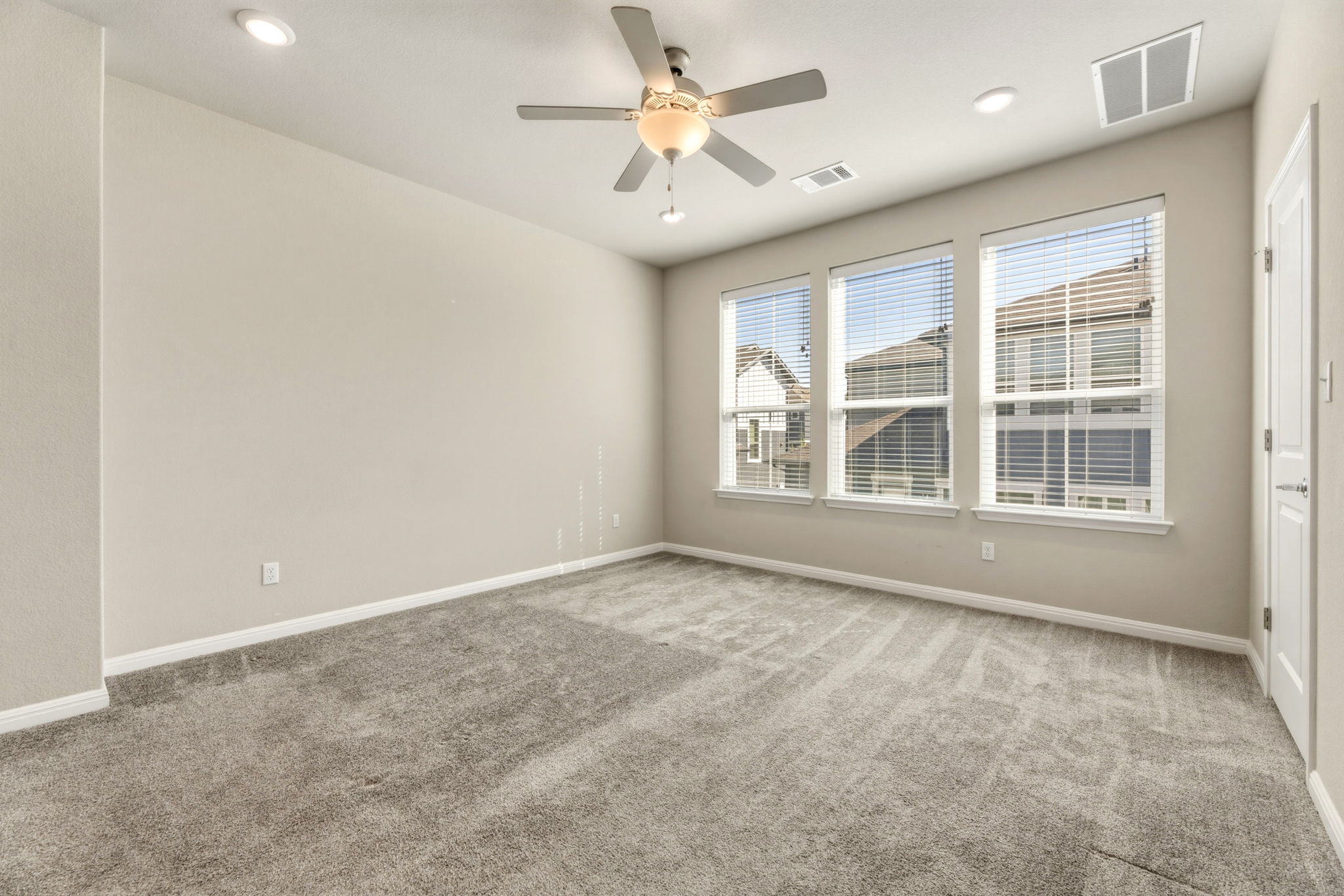 1015 Vista View Drive, Unit 2102 Georgetown, TX 78626 - Photo 20 of 40 an empty room with windows and fan