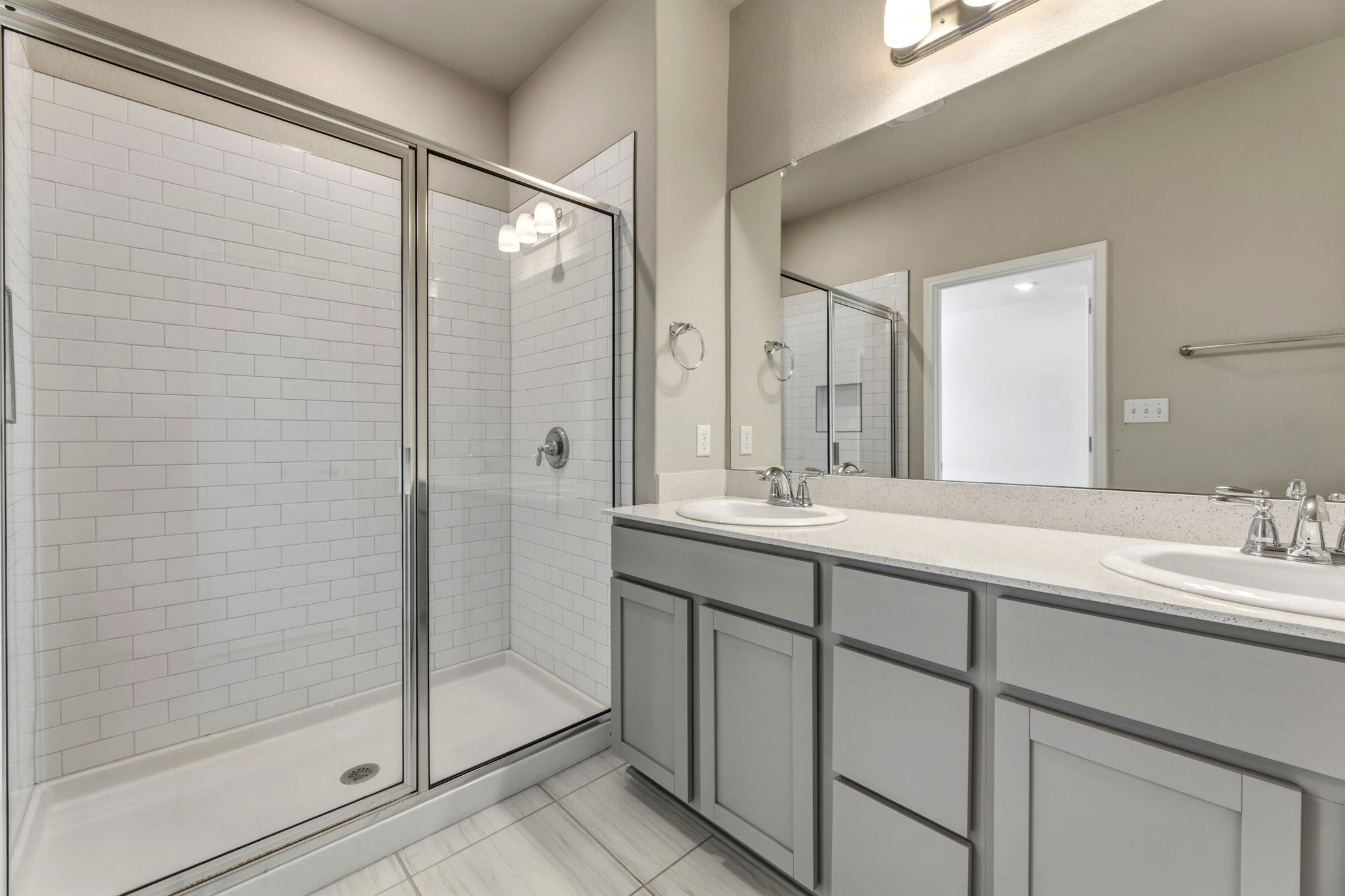 1015 Vista View Drive, Unit 2102 Georgetown, TX 78626 - Photo 23 of 40 a bathroom with a double vanity sink mirror and shower