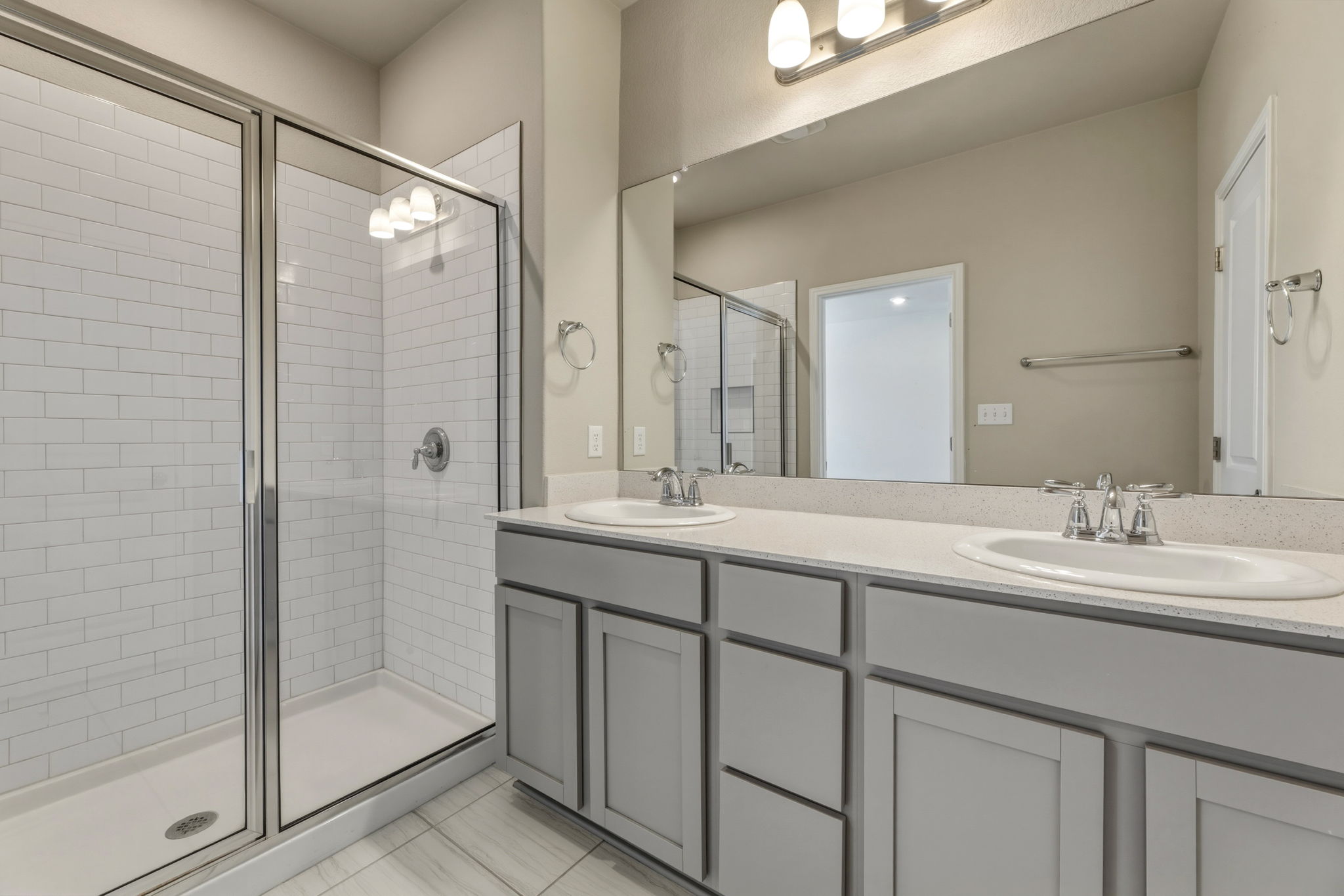 1015 Vista View Drive, Unit 2102 Georgetown, TX 78626 - Photo 24 of 40 a bathroom with a double vanity sink mirror and shower